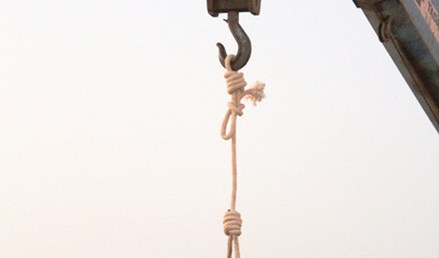 Two prisoners were hanged publicly in southern Iran this morning